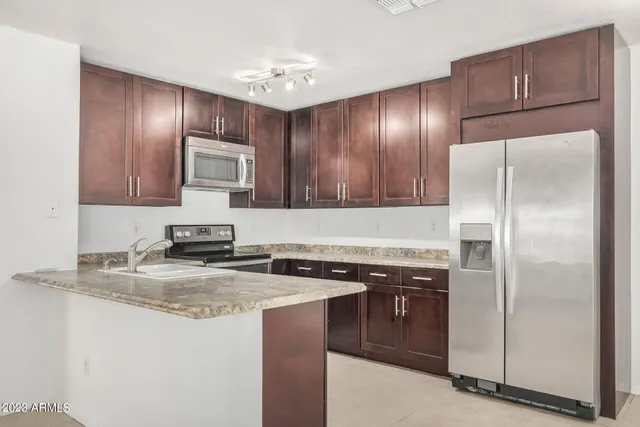a view of a room with a ceiling fan and a window