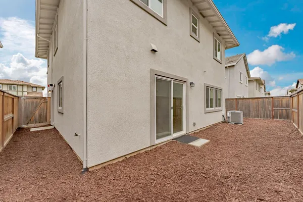 a view of a house with backyard and deck