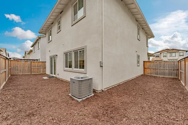 a view of a house with wooden fence