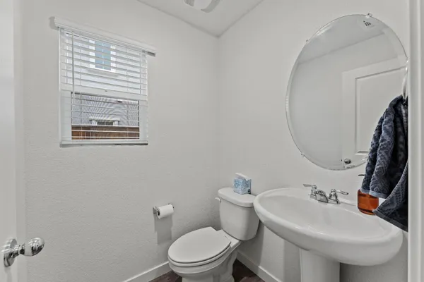 a bathroom with a sink toilet and a mirror