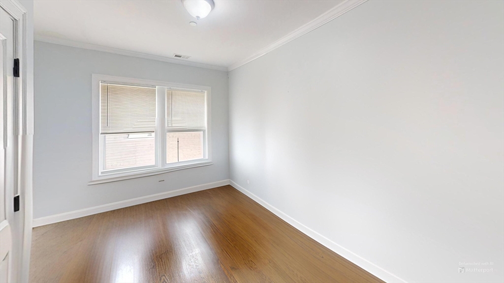 2969 Washington Street, Unit 2 Boston, MA 02119 - Photo 4 of 7 an empty room with wooden floor and windows