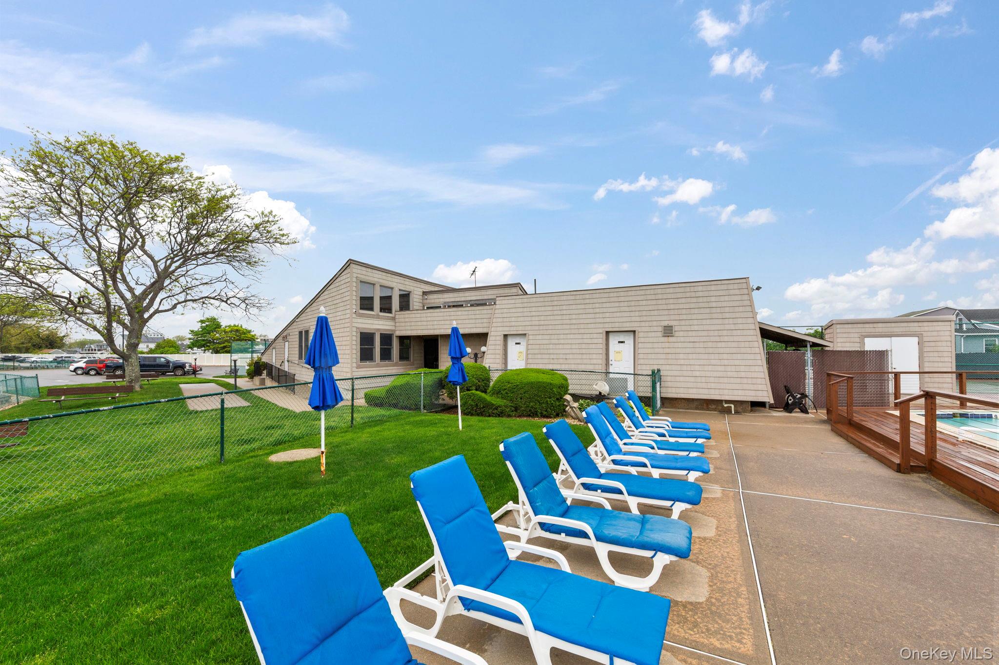 248 Mariners Way Copiague, NY 11726 - Photo 15 of 18 a view of a chairs and table in backyard of the house