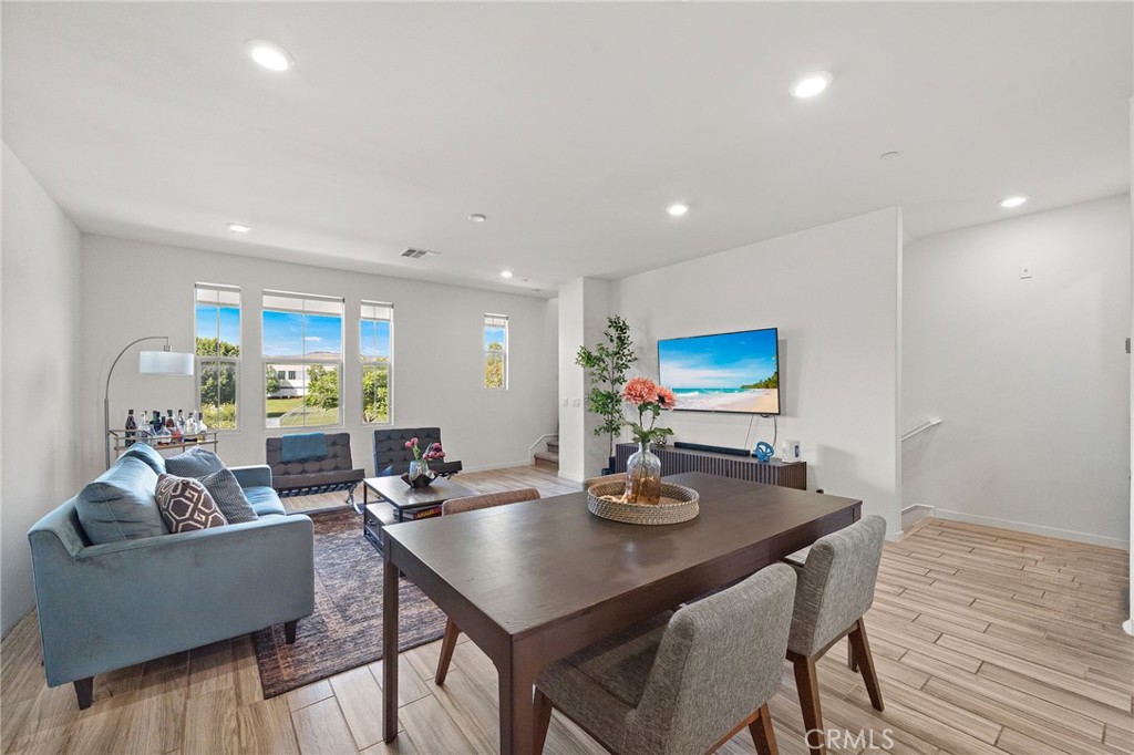 144 Paramount Irvine, CA 92618 - Photo 11 of 43 a living room with furniture and wooden floor