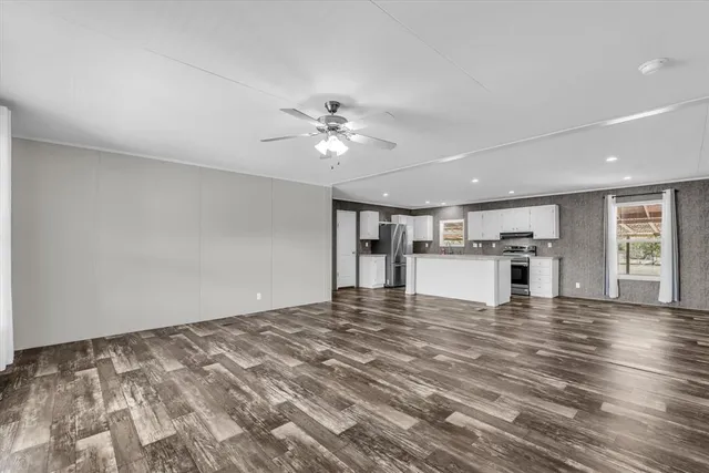 a view of an empty room with a kitchen