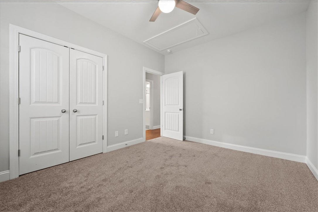 102 Ripplestone Way Anderson, SC 29621 - Photo 17 of 39 A well-lit bedroom features plush carpeting and a convenient ceiling fan for comfort.