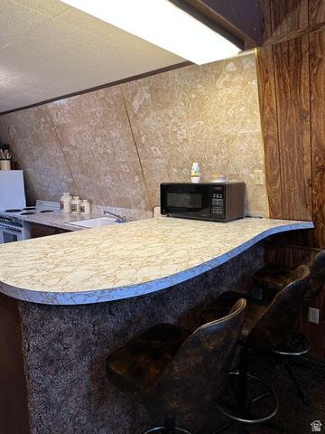 1085 West Elk Road Helper, UT 84526 - Photo 13 of 40 Kitchen island with a curved countertop and integrated breakfast bar