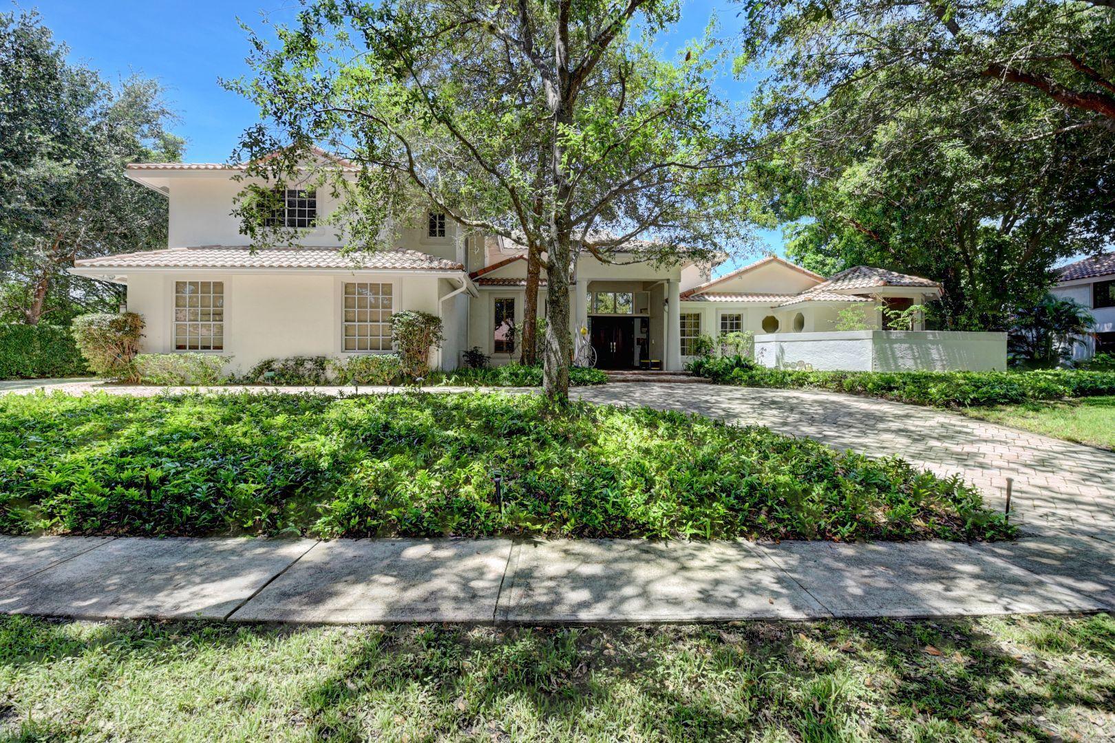 2375 Northwest 41st Street Boca Raton, FL 33431 - Photo 2 of 38 a front view of a house with a yard and potted plants
