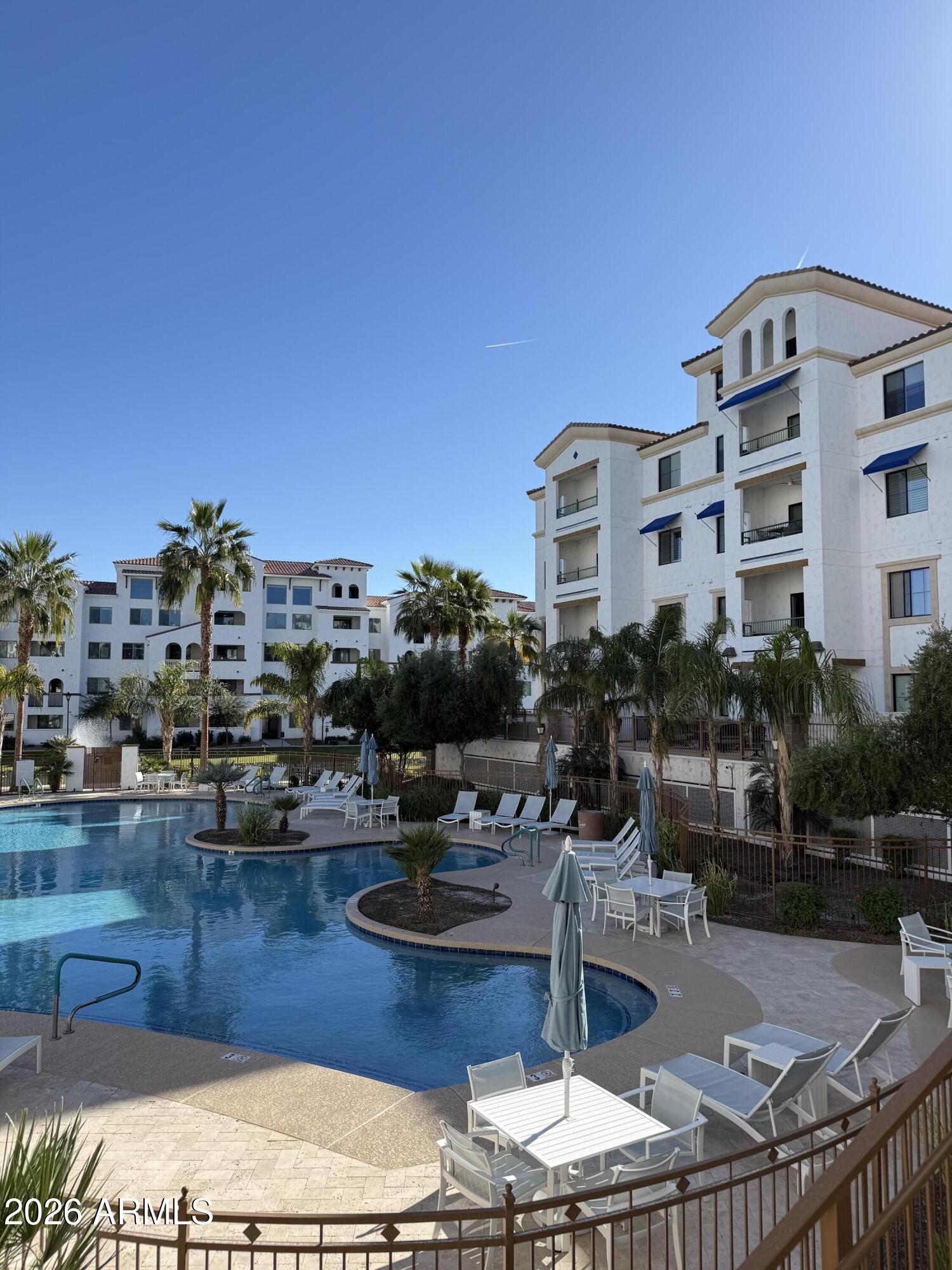 a view of a swimming pool with outdoor seating