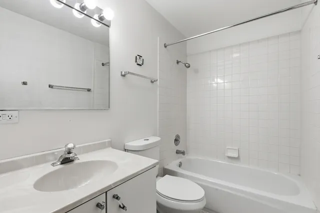 a bathroom with a sink toilet a mirror and shower