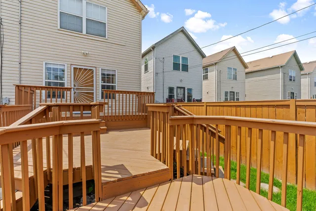 a view of a house with wooden deck