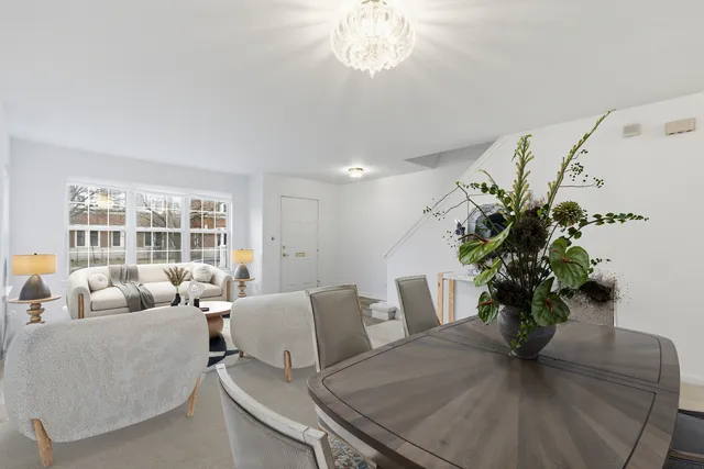a living room with furniture flowerpot and wooden floor