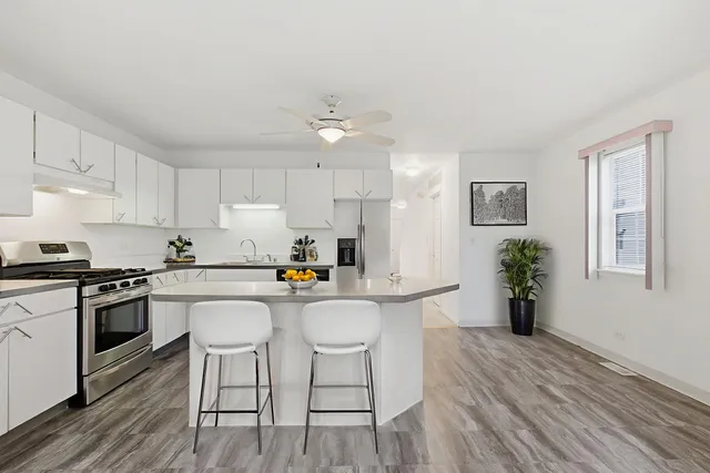 a kitchen with stainless steel appliances a white cabinets stove and refrigerator