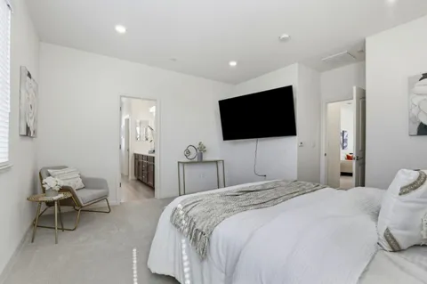 a bedroom with a bed and a couch