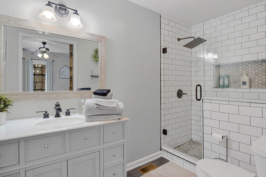 45 Wilderness Trail Blue Ridge, GA 30513 - Photo 31 of 58 a bathroom with a shower sink and mirror