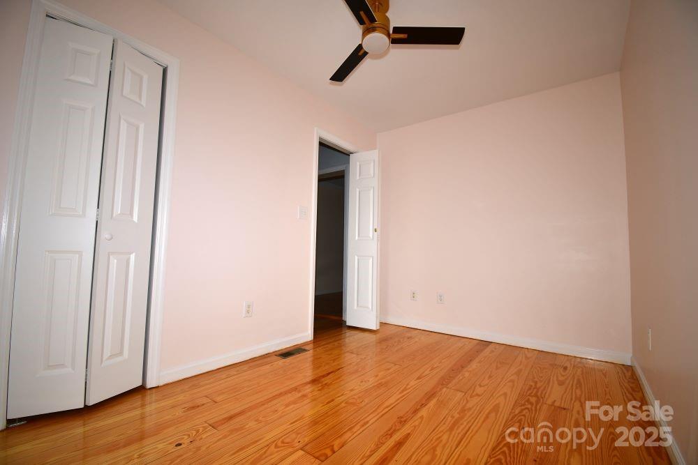 2171 John G Richards Road Camden, SC 29020 - Photo 11 of 21 an empty room with wooden floor and windows