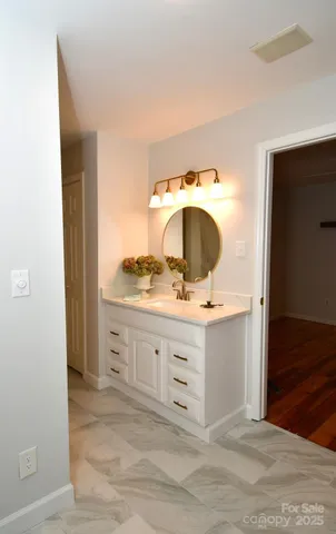 a view of small space with wooden floor and mirror