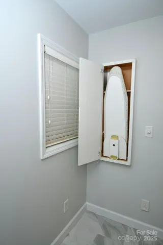 a kitchen with a sink cabinets and wooden floor