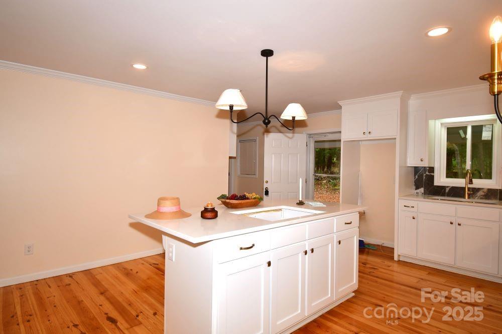 2171 John G Richards Road Camden, SC 29020 - Photo 10 of 21 a kitchen with a sink cabinets and wooden floor