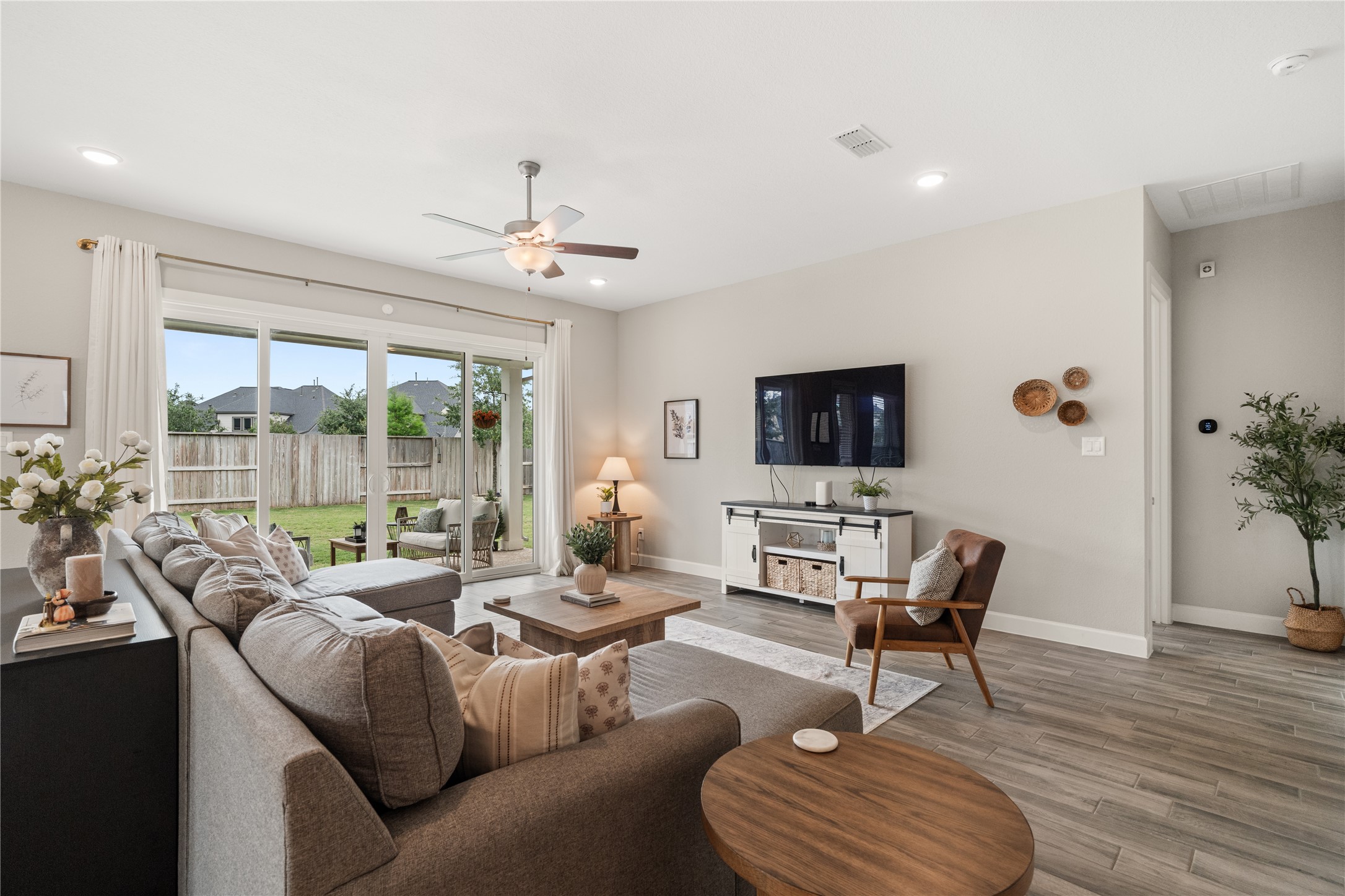 3118 Swift Way Katy, TX 77493 - Photo 14 of 34 Living Room to Patio View – Sliding glass doors provide easy indoor-outdoor access and views of the backyard, enhancing natural light throughout the space.