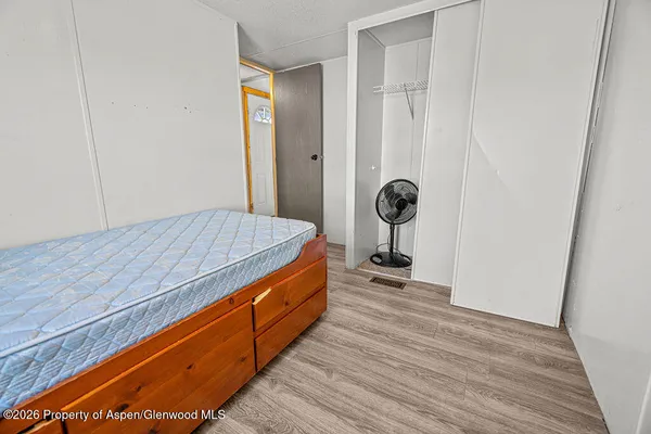 a room with natural light and hardwood floor