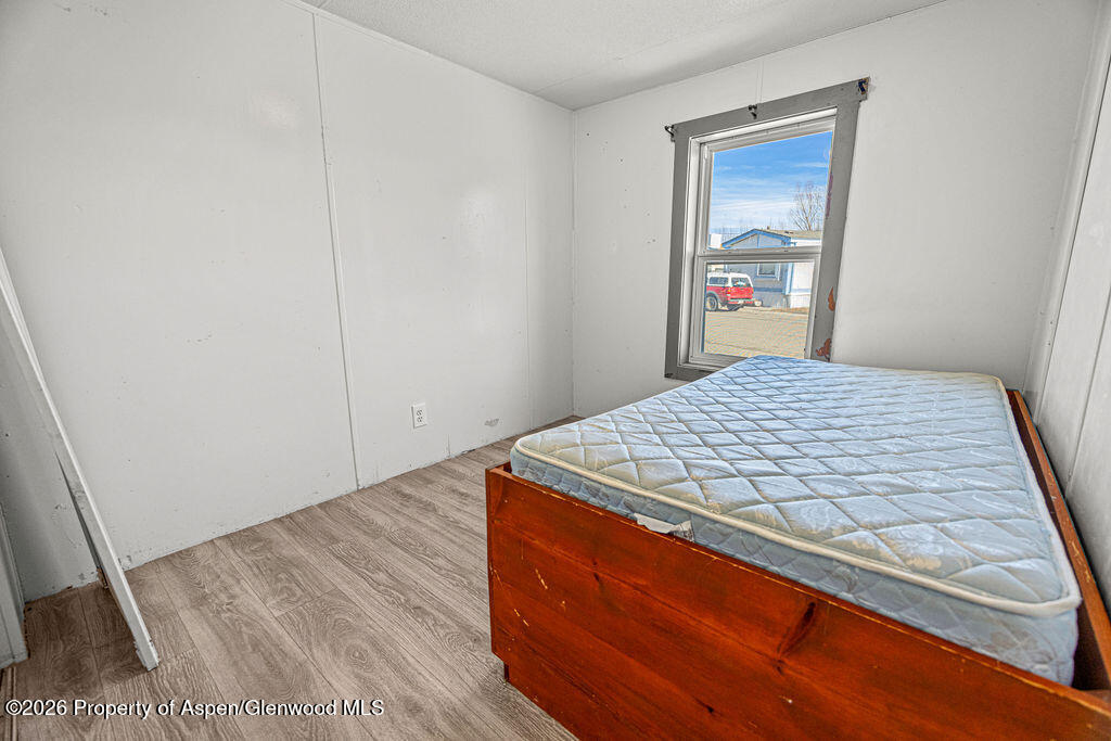 2210 West 3rd Street, Unit 38 Craig, CO 81625 - Photo 18 of 22 a bed sitting in a bedroom next to a window