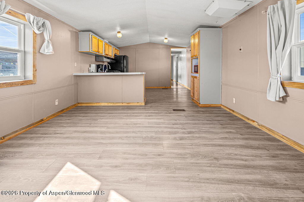 2210 West 3rd Street, Unit 38 Craig, CO 81625 - Photo 7 of 22 a view of a kitchen with wooden floor and a large window