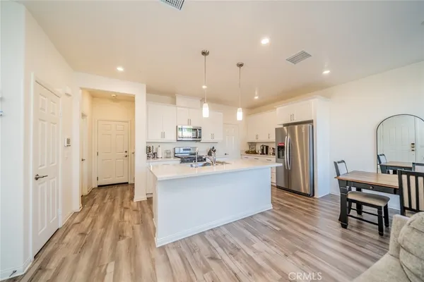 a view of kitchen with sink and refrigerator