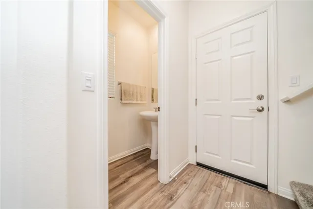 a view of a hallway with wooden floor