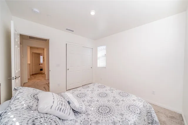 a bedroom with a bed and a desk