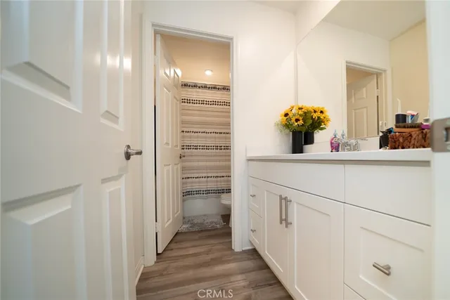 a bathroom with a toilet and a shower curtain