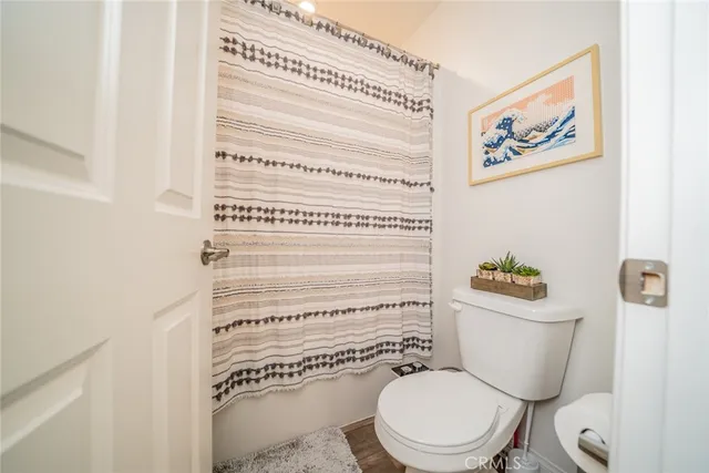 a bedroom with bed tv and window