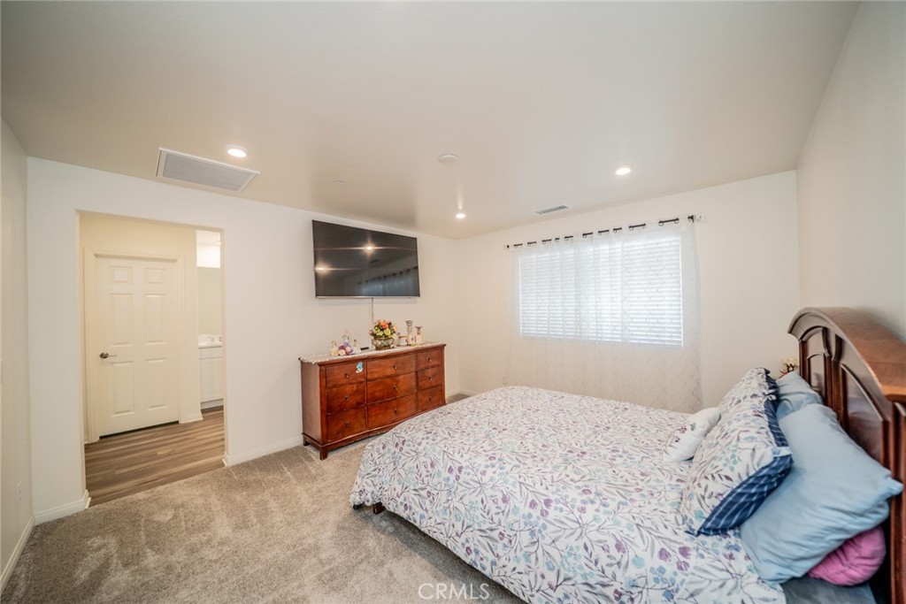 214 Bonita Lane Rialto, CA 92376 - Photo 34 of 51 a bedroom with a bed and a flat screen tv
