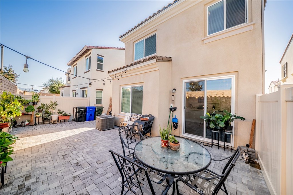 214 Bonita Lane Rialto, CA 92376 - Photo 40 of 51 a view of a patio with a table and chairs in front of house