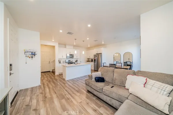 a living room with furniture and kitchen view