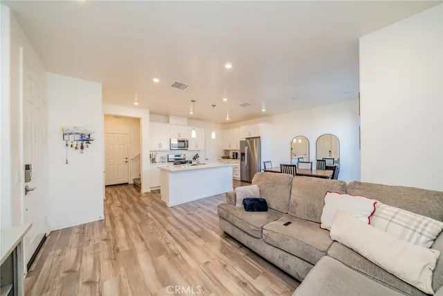 a living room with furniture and kitchen view