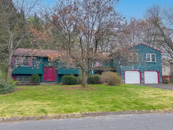 a view of a house with yard and tree s