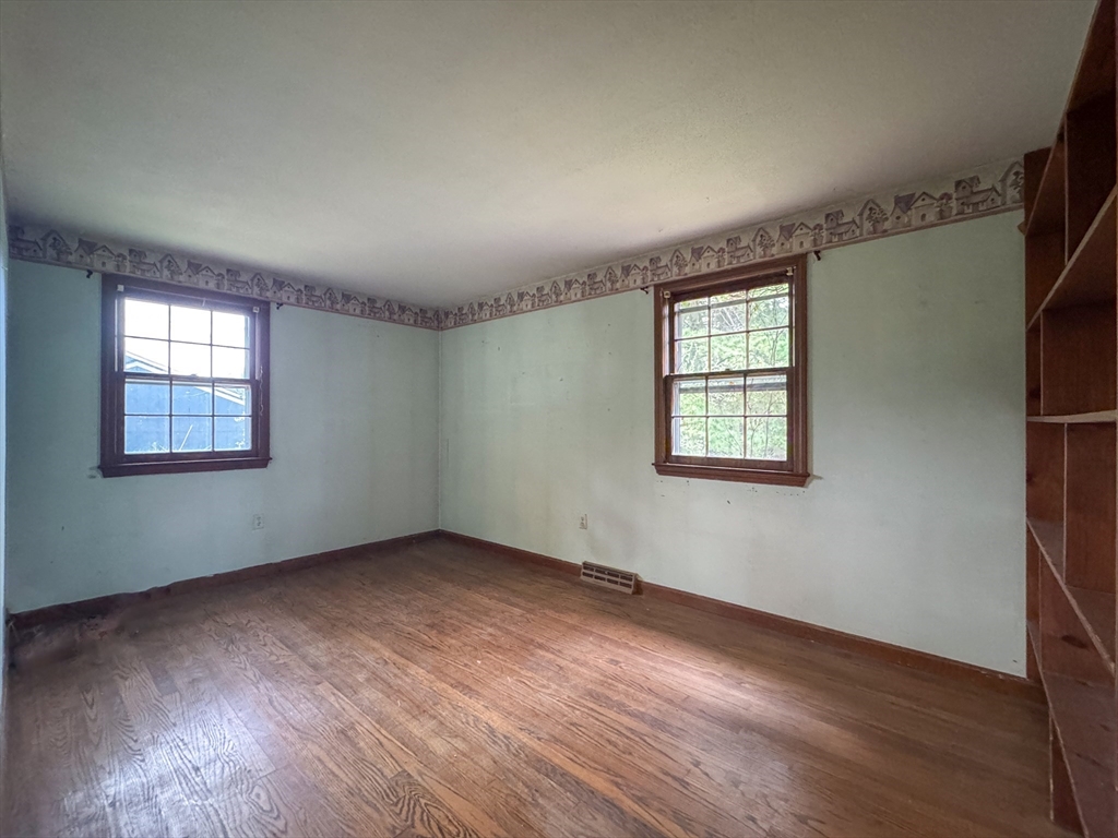 60 White Fox Road Feeding Hills, MA 01030 - Photo 12 of 29 an empty room with wooden floor and windows