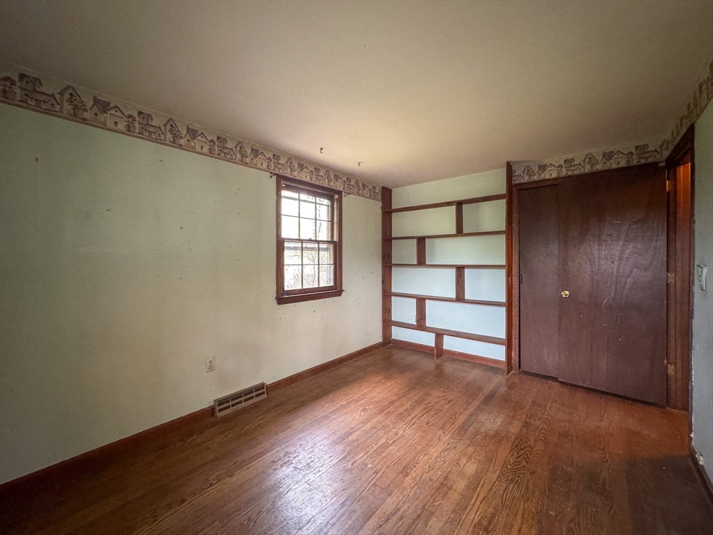 60 White Fox Road Feeding Hills, MA 01030 - Photo 13 of 29 a view of an empty room with a window and wooden floor