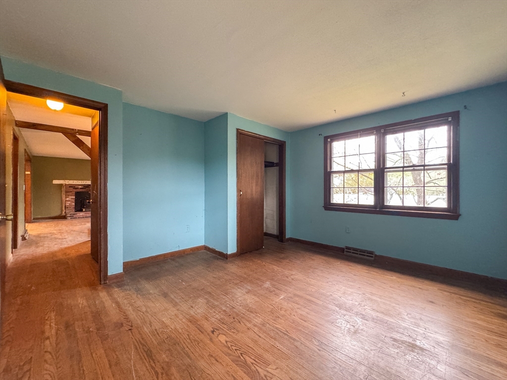 60 White Fox Road Feeding Hills, MA 01030 - Photo 15 of 29 an empty room with a window and wooden floor