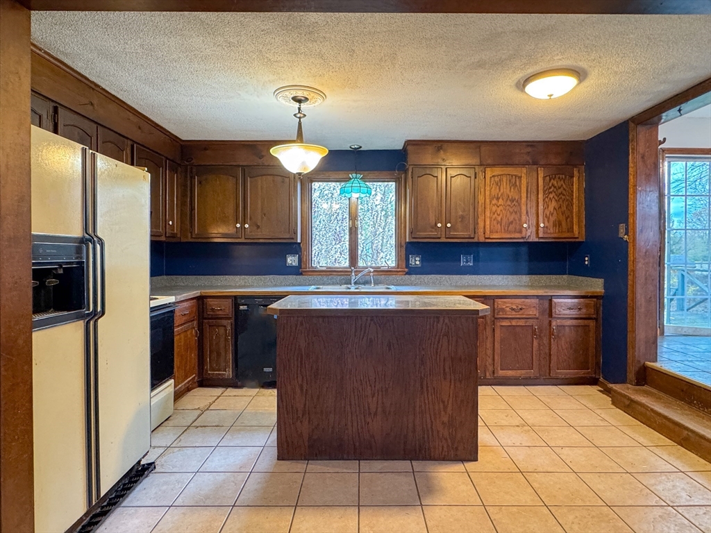 60 White Fox Road Feeding Hills, MA 01030 - Photo 19 of 29 a kitchen with stainless steel appliances granite countertop a refrigerator and a stove