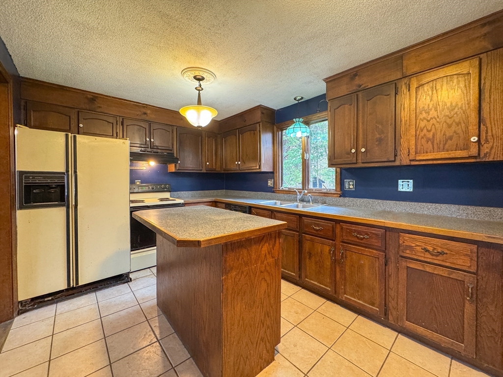 60 White Fox Road Feeding Hills, MA 01030 - Photo 20 of 29 a kitchen with granite countertop a sink a counter space and cabinets