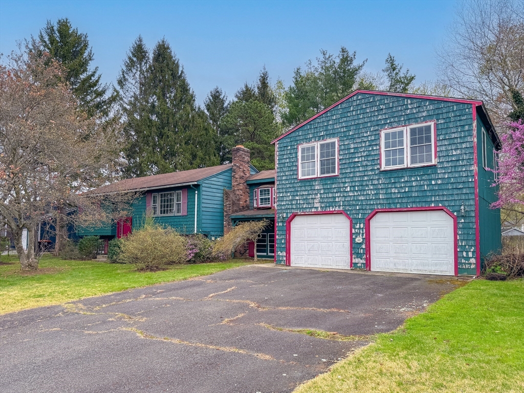 60 White Fox Road Feeding Hills, MA 01030 - Photo 2 of 29 a front view of a house with a yard and garage