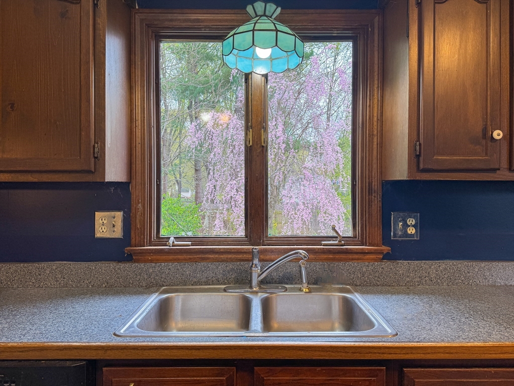 60 White Fox Road Feeding Hills, MA 01030 - Photo 21 of 29 a kitchen with a sink and a large mirror next to a window
