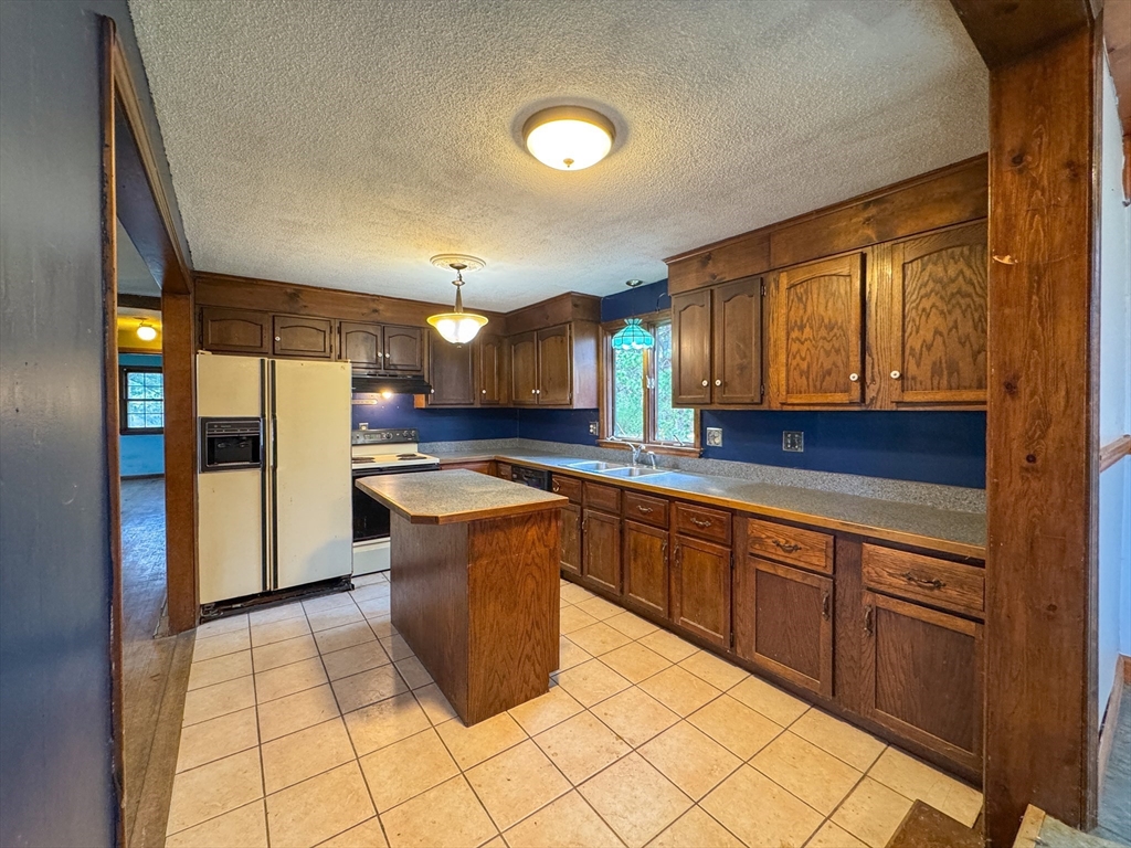 60 White Fox Road Feeding Hills, MA 01030 - Photo 22 of 29 a large kitchen with stainless steel appliances granite countertop a refrigerator and a stove top oven