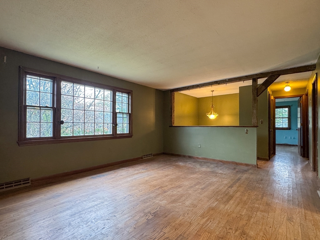 60 White Fox Road Feeding Hills, MA 01030 - Photo 10 of 29 an empty room with wooden floor and windows