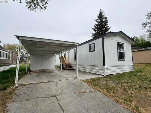 a view of a house with a white fence