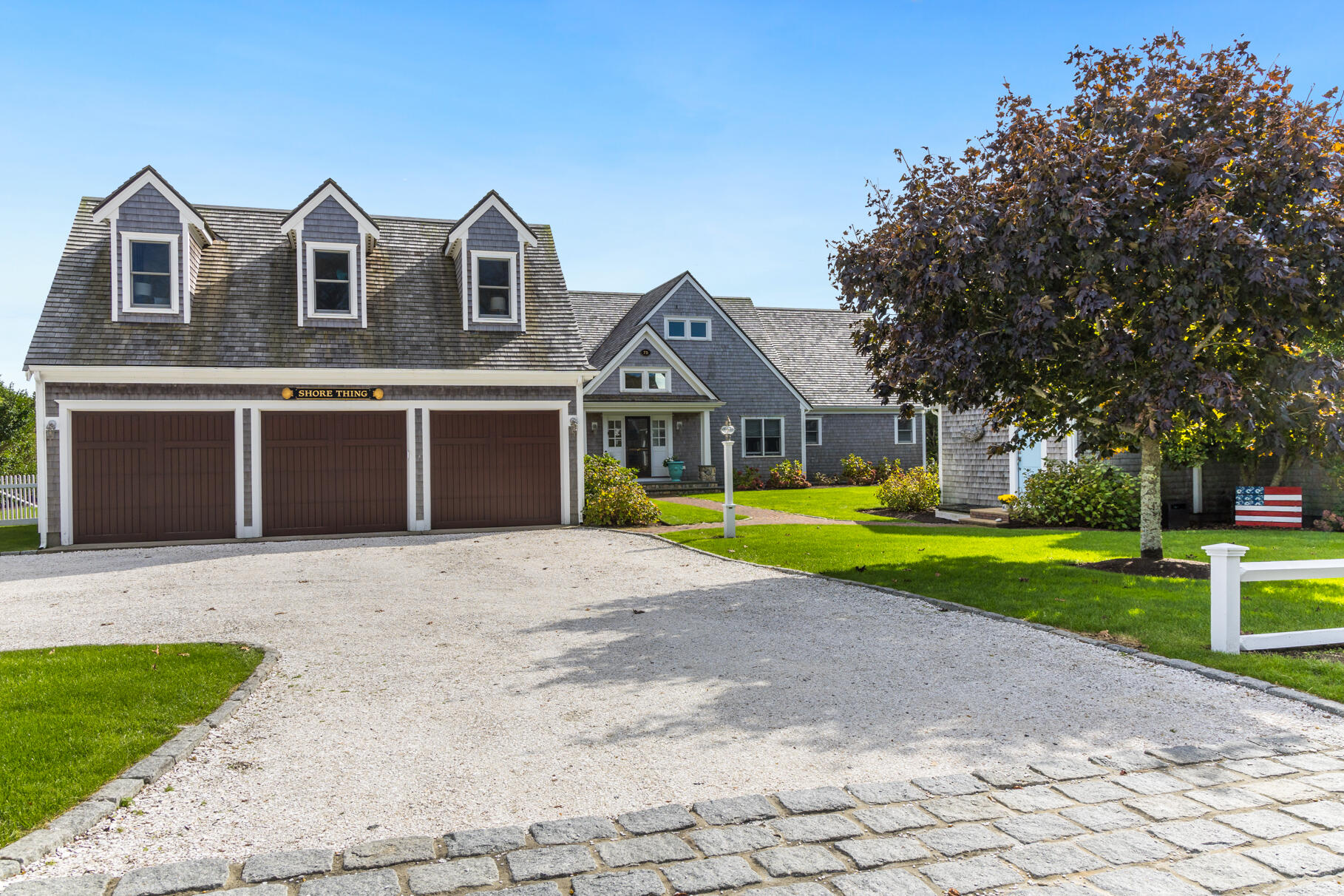 75 Shore Road West Harwich, MA 02671 - Photo 12 of 53 a front view of a house with a yard and garage