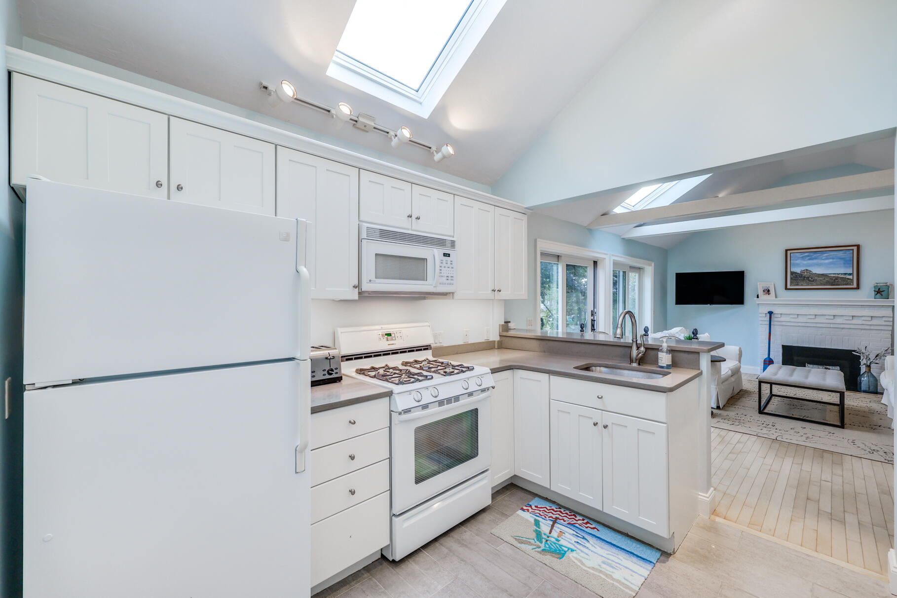 75 Shore Road West Harwich, MA 02671 - Photo 50 of 53 a kitchen with white cabinets and white appliances