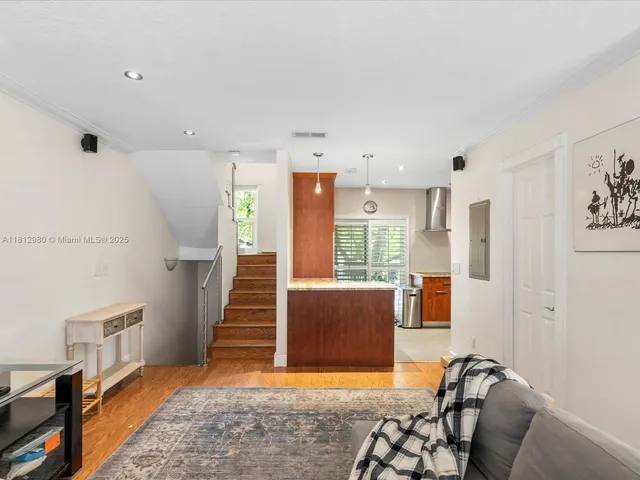 a view of a livingroom with furniture and staircase