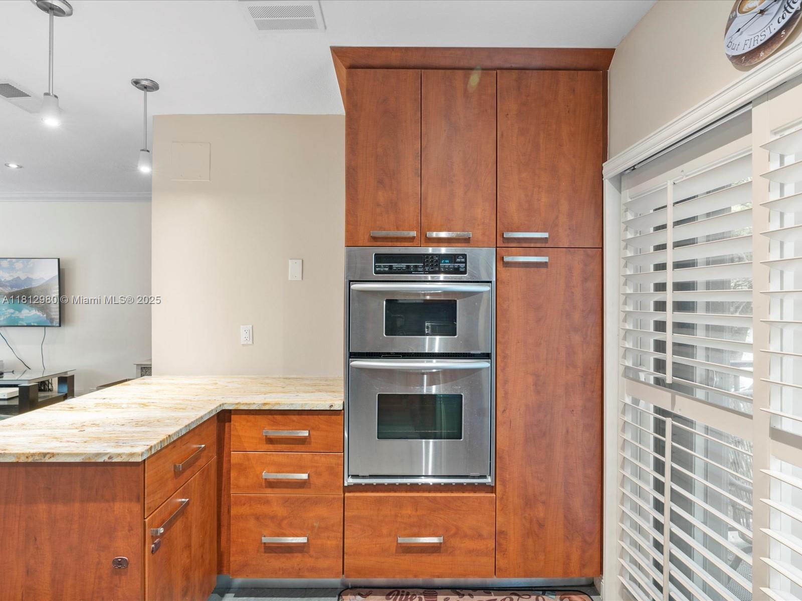 3097 Bird Avenue, Unit 3097 Miami, FL 33133 - Photo 11 of 29 a kitchen with stainless steel appliances granite countertop a stove and a refrigerator